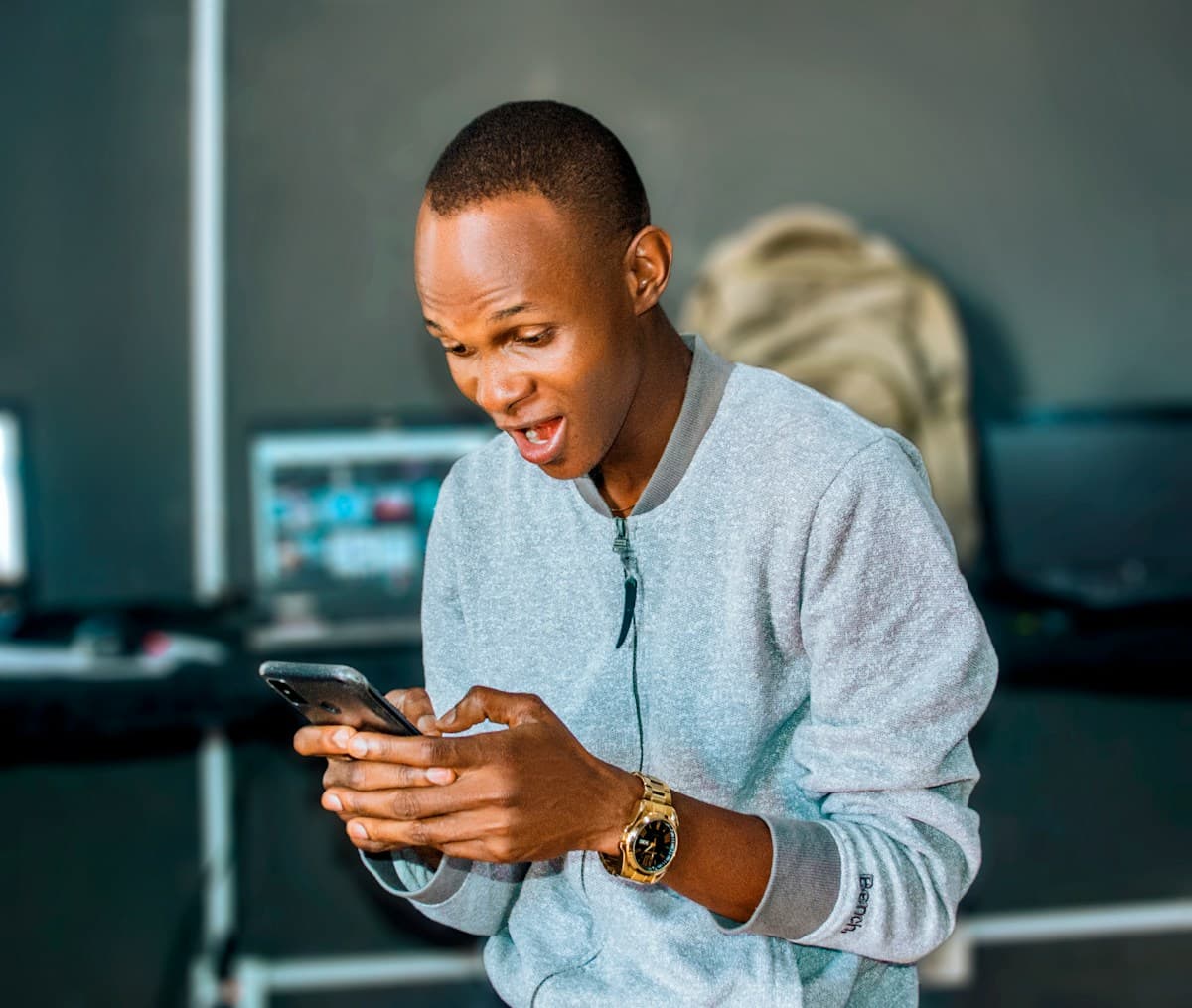 A business owner delighted at a payment notification on his phone